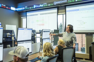 Instructor teaching in the Agricultural Business Degree commodities trading room inside the Mars Ag Center at Sheridan College