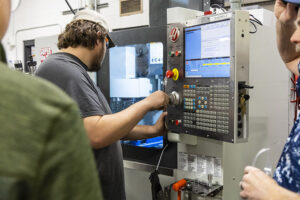 Student using a CNC machine in the machine tool program