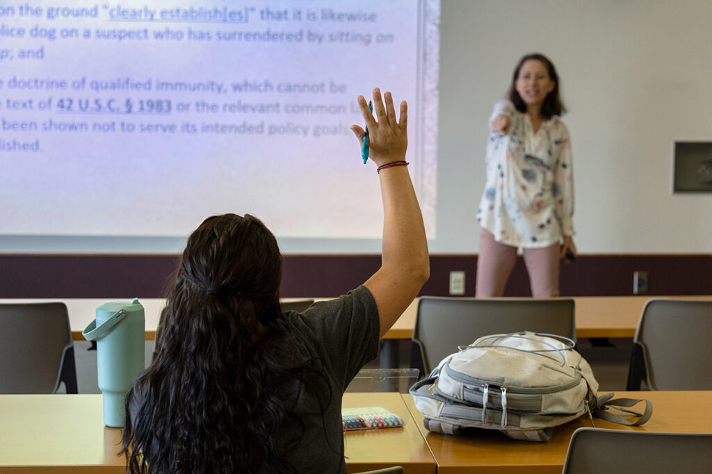 Sheridan College Criminal Justice photo of student raising her hand and being called upon by instructor.