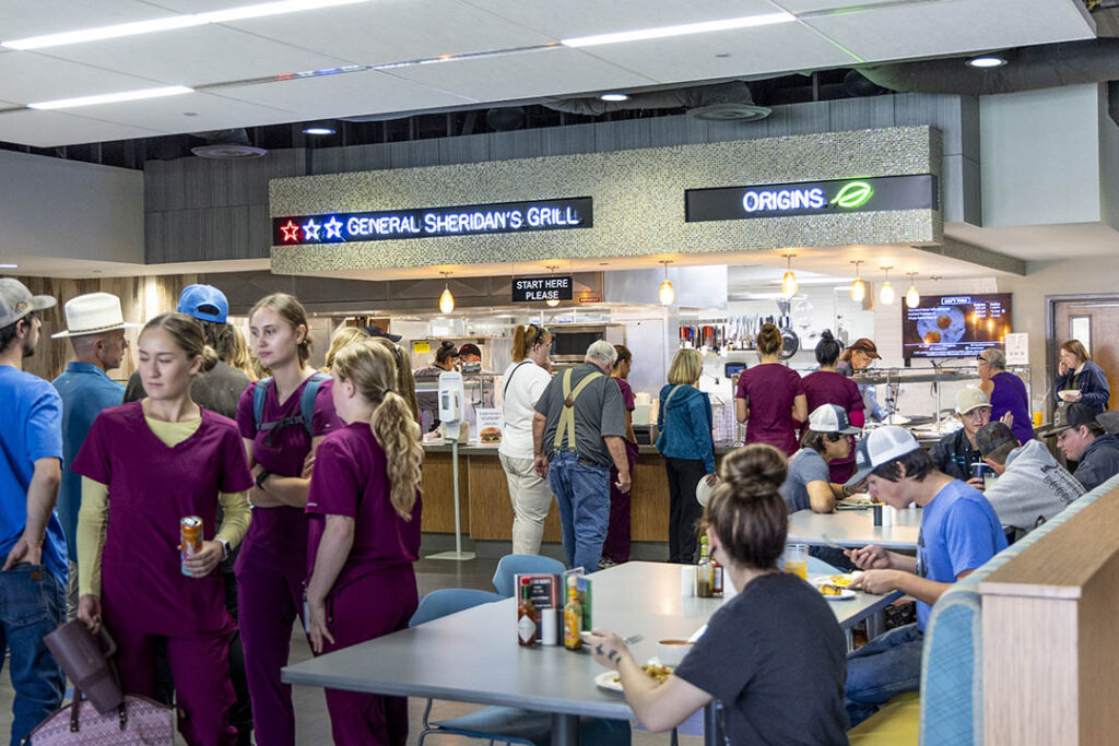 Image of students, community, and faculty eating and order food in the Griffith Dining Commons.