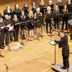 Photo of the Sheridan College Collegiate Choir performing with Dr. Robert Psurny directing.