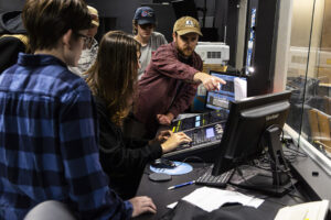 jake showing students how to set up lighting scenes