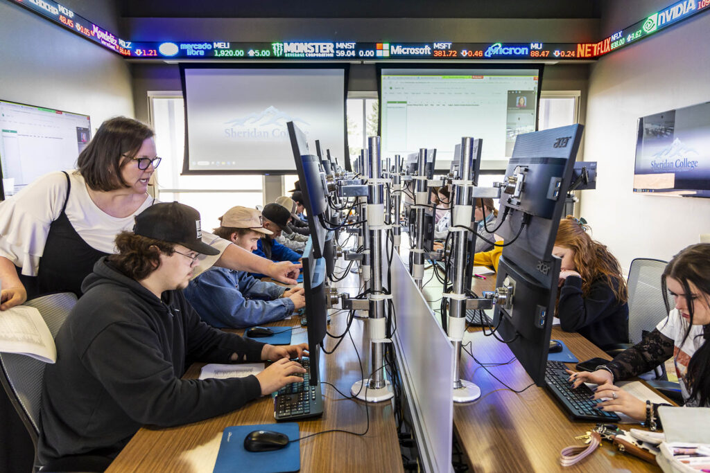 Sheridan College instructor teaching an agriculture business class in the commodities trading room at Sheridan College