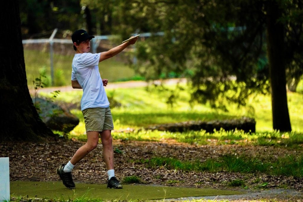 Guy playing frisbee golf