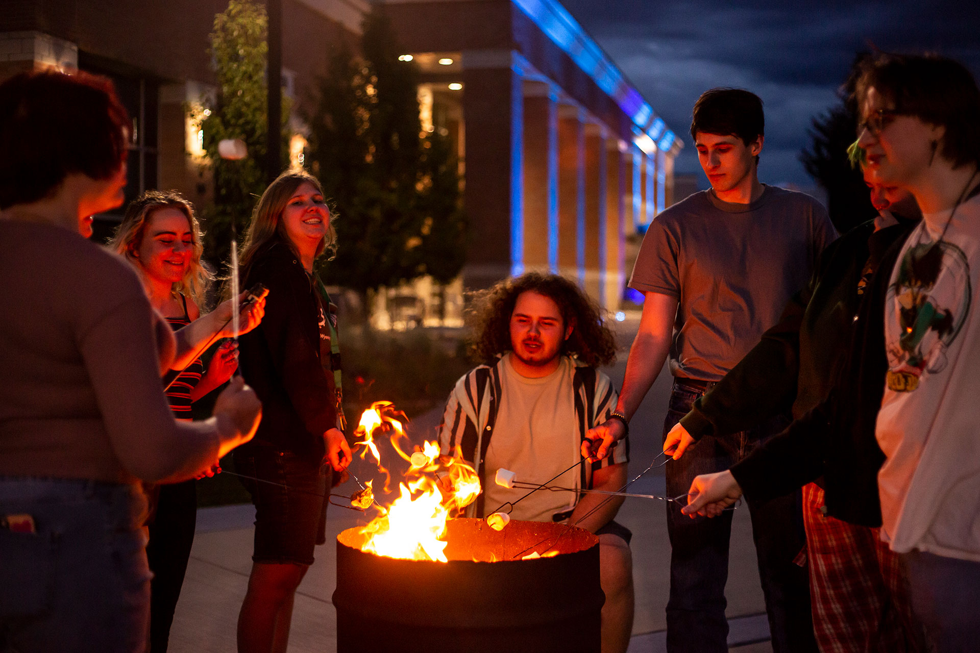 Sheridan College students roasting marshmallows outside the Thorne-Rider Community Center.