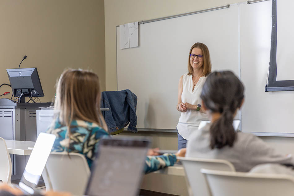 Image of a business class with instructor at the whiteboard