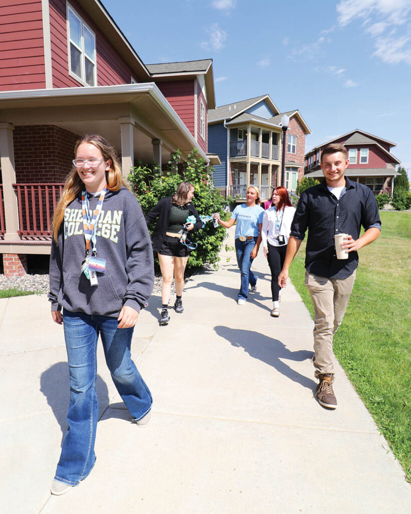 Students walking past Whitney Villas