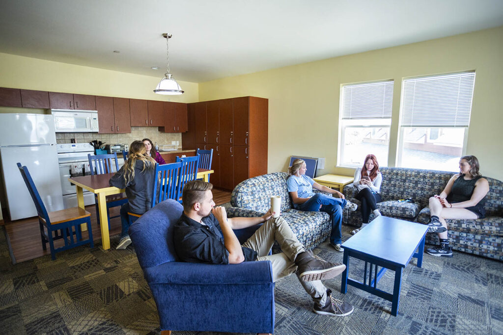 Students hanging out in a livingroom of one of the Villas