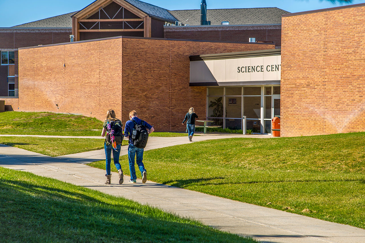 Sheridan College Science Center photo with students walking.