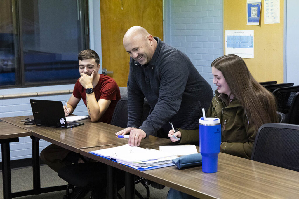 Instructor helping a couple of math students at Sheridan College in Johnson County