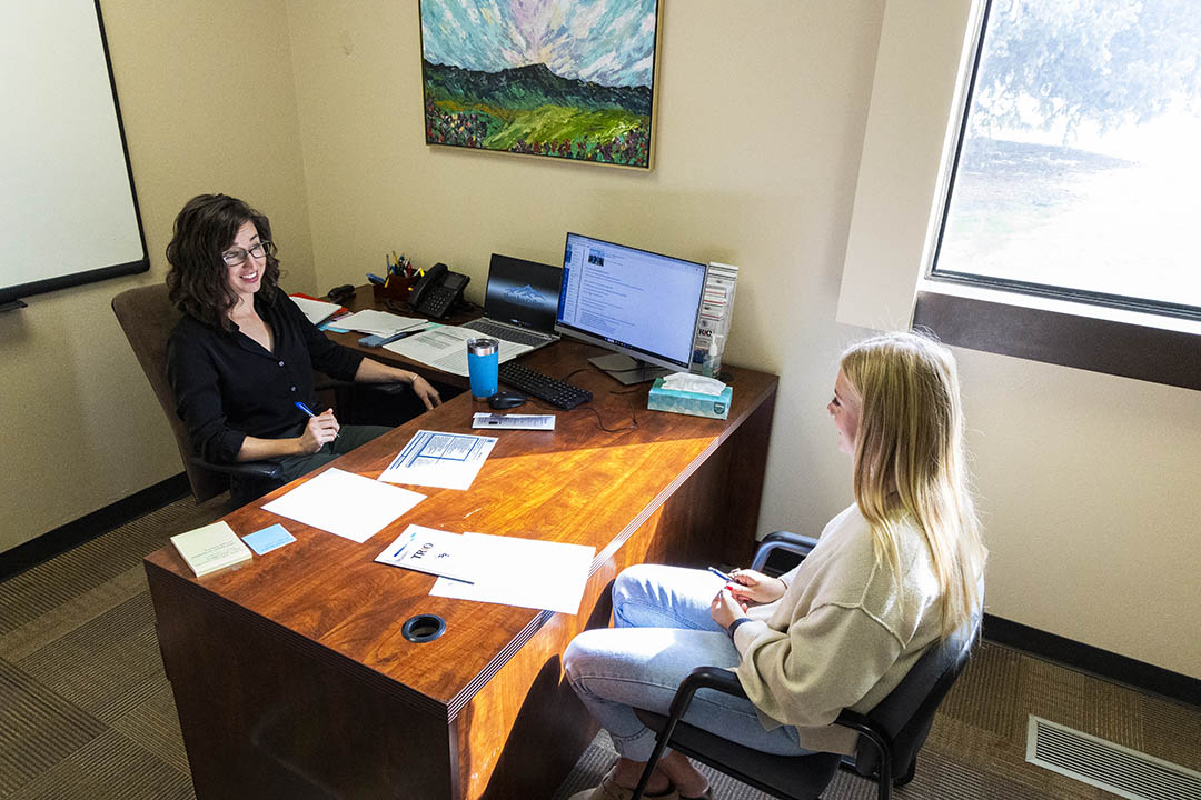 Sheridan College Trio and College Success councilor chatting with a student in their office